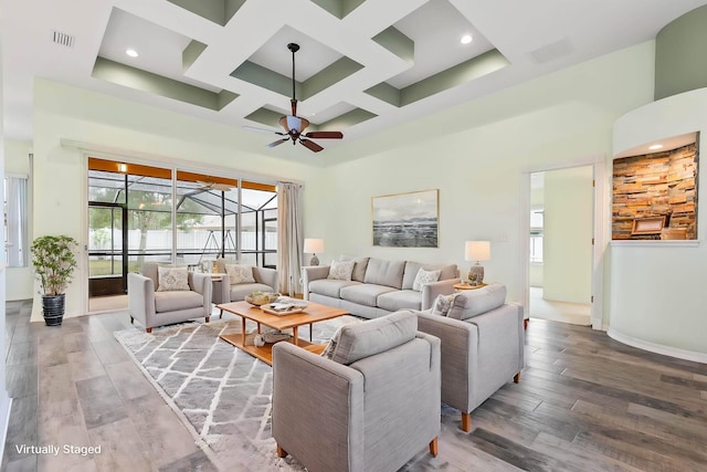 4 Eastgate Ln, Palm Coast, FL 32164 - living area with a towering ceiling, a ceiling fan, coffered ceiling, healthy amount of natural light, and baseboards