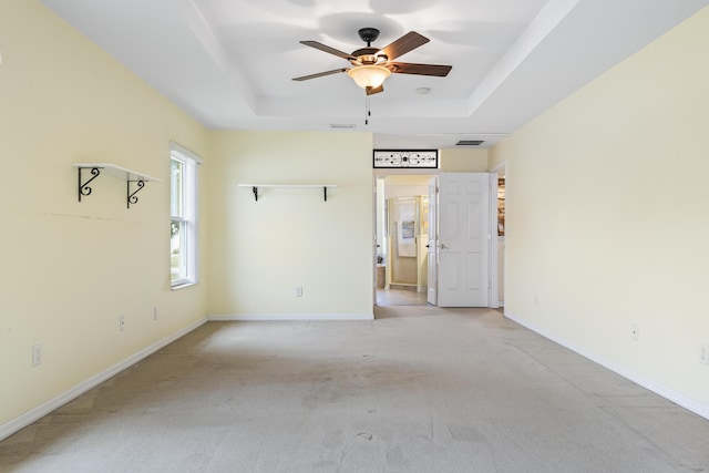 4 Eastgate Ln, Palm Coast, FL 32164 - unfurnished room featuring a raised ceiling, a ceiling fan, and light colored carpet