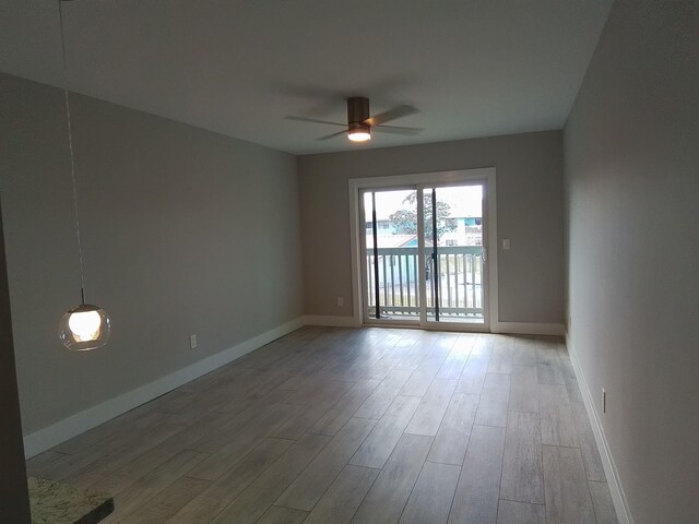 empty room with wood-type flooring and ceiling fan