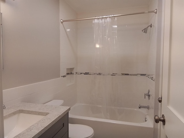 full bathroom featuring toilet, shower / tub combo with curtain, vanity, and tile walls