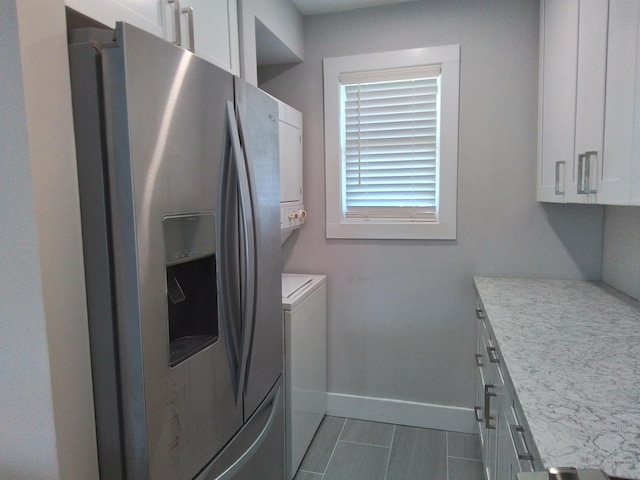 laundry area featuring dark tile patterned flooring