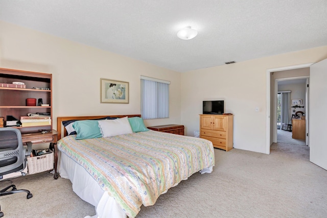 carpeted bedroom with a textured ceiling