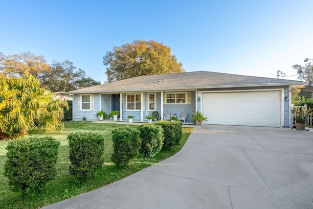 ranch-style house with a garage, a front yard, and driveway