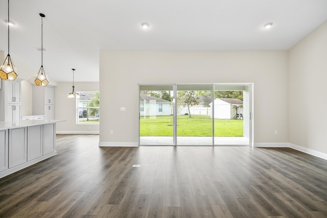 spare room featuring a notable chandelier and dark hardwood / wood-style floors