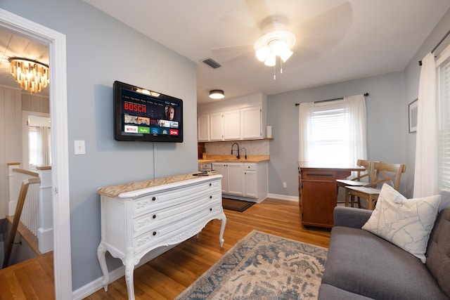 6 E Park Ave, Saint Augustine, FL 32084 - living room with light wood-style floors, ceiling fan, plenty of natural light, and a chandelier