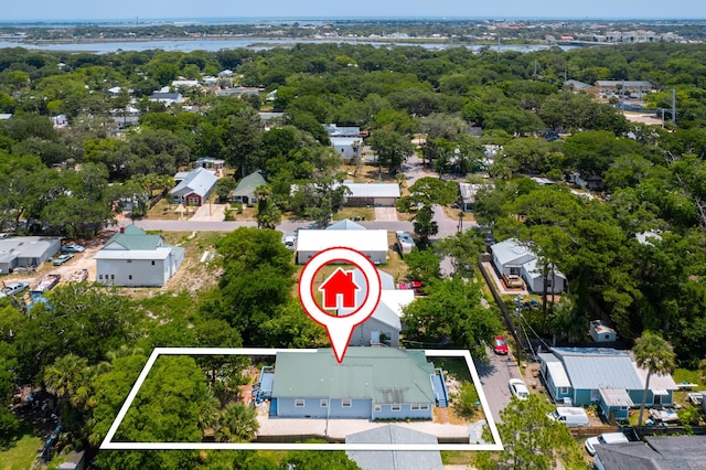 birds eye view of property featuring a view of trees