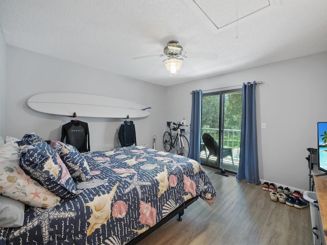 bedroom featuring hardwood / wood-style flooring, ceiling fan, a textured ceiling, and access to outside