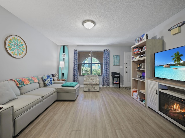 living room with light hardwood / wood-style flooring and a textured ceiling