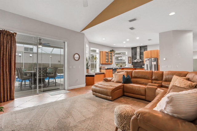 living room featuring light tile patterned floors and vaulted ceiling