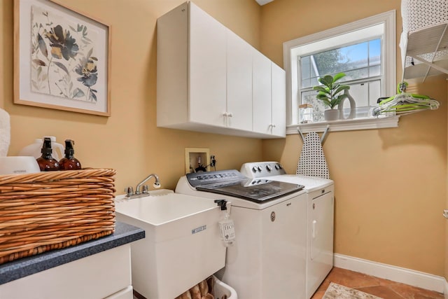 laundry area featuring cabinets, independent washer and dryer, and sink