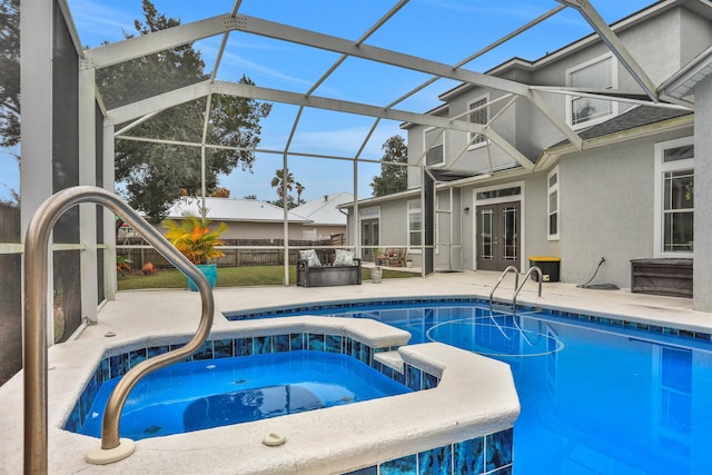 view of pool with french doors, sink, a lanai, a patio area, and an in ground hot tub