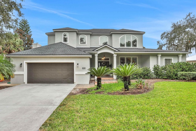 view of front of property featuring a garage and a front yard