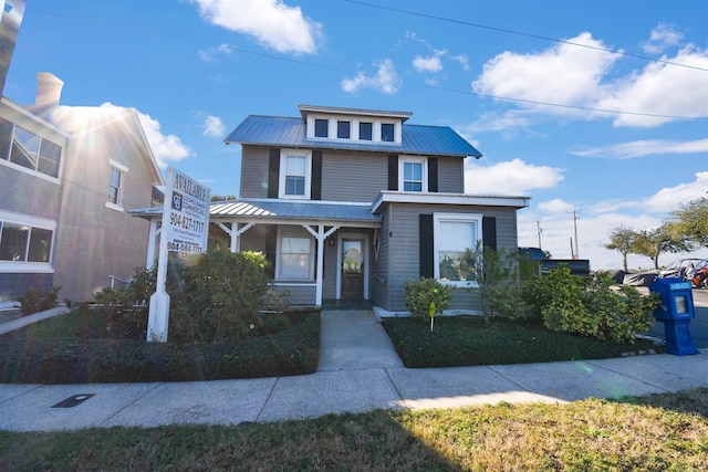 american foursquare style home featuring metal roof