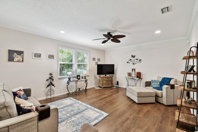 living room featuring ceiling fan, hardwood / wood-style floors, a textured ceiling, and ornamental molding