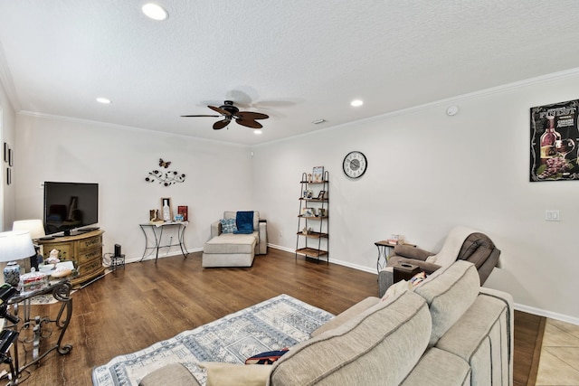 living room with crown molding, ceiling fan, a textured ceiling, and hardwood / wood-style flooring