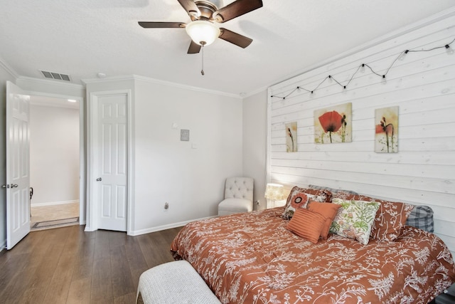 bedroom with ornamental molding, ceiling fan, and dark wood-type flooring