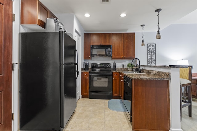 kitchen featuring sink, hanging light fixtures, kitchen peninsula, dark stone countertops, and black appliances