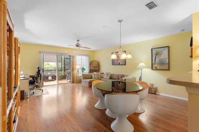 662 Cabernet Pl, Saint Augustine, FL 32084 - living room with an office area, wood finished floors, a chandelier, and a ceiling fan