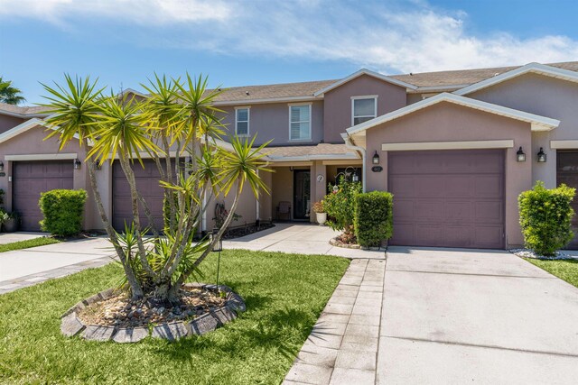 662 Cabernet Pl, Saint Augustine, FL 32084 - view of front facade featuring driveway, a garage, stucco siding, and a front lawn