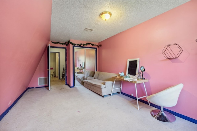 home office featuring carpet floors and a textured ceiling