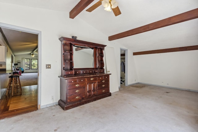 unfurnished living room with light carpet, lofted ceiling with beams, and ceiling fan