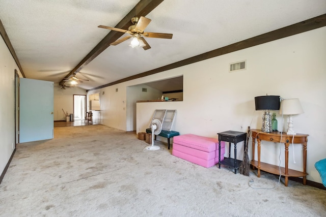 carpeted living room with beam ceiling, a textured ceiling, and ceiling fan