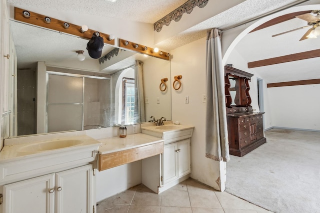 bathroom featuring tile patterned floors, ceiling fan, a shower with door, and a textured ceiling