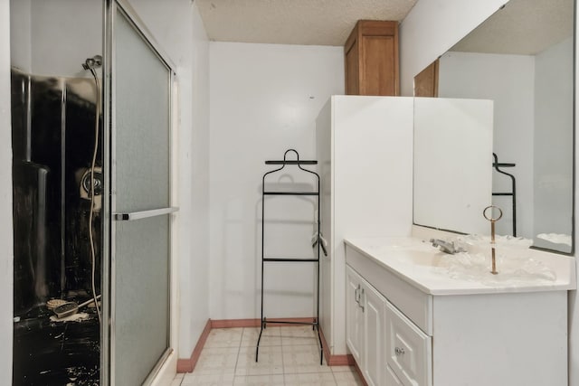 bathroom with vanity, a textured ceiling, and walk in shower