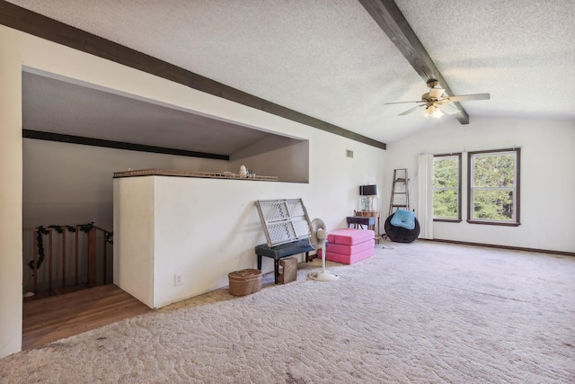 rec room with carpet flooring, vaulted ceiling with beams, ceiling fan, and a textured ceiling