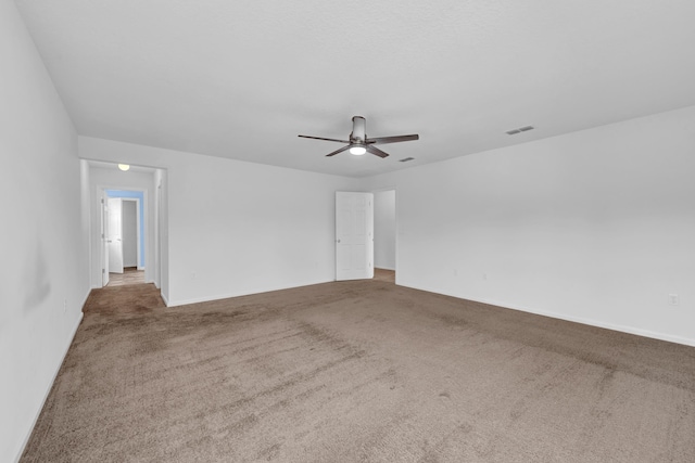 empty room with ceiling fan and carpet