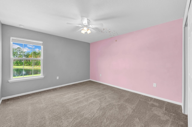 empty room with ceiling fan and carpet