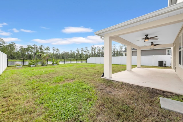 view of yard with a water view, central AC unit, a patio area, and ceiling fan