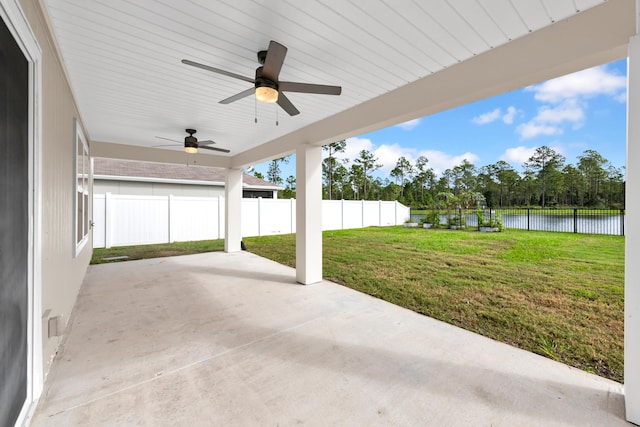 view of patio featuring a water view and ceiling fan