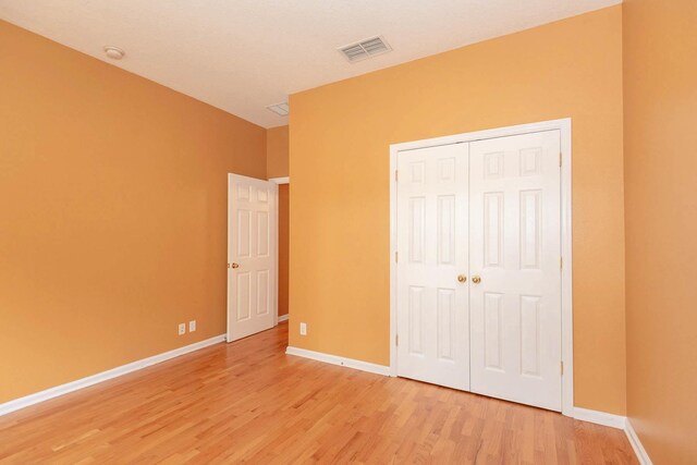 902 Heron Point Cir, Deland, FL 32724 - unfurnished bedroom featuring light wood-type flooring, baseboards, and a closet