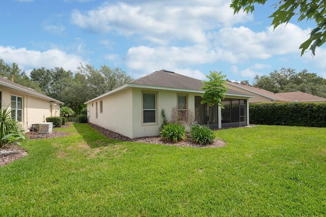 902 Heron Point Cir, Deland, FL 32724 - back of property with a yard, a sunroom, stucco siding, and central AC unit
