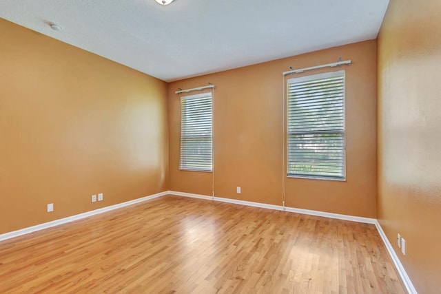 902 Heron Point Cir, Deland, FL 32724 - empty room with light wood finished floors, healthy amount of natural light, baseboards, and a smoke detector