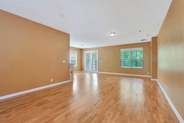 902 Heron Point Cir, Deland, FL 32724 - unfurnished room with light wood-style flooring, plenty of natural light, and baseboards