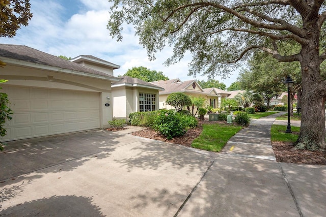 902 Heron Point Cir, Deland, FL 32724 - view of front of house featuring stucco siding, concrete driveway, and a garage