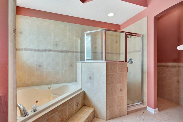 902 Heron Point Cir, Deland, FL 32724 - bathroom featuring a shower stall, tile patterned flooring, a whirlpool tub, tile walls, and a textured ceiling