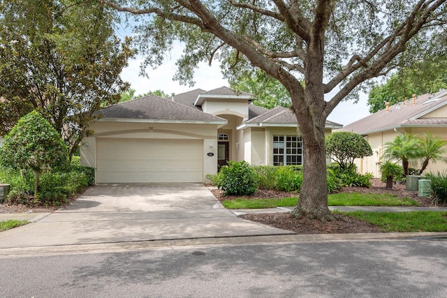 902 Heron Point Cir, Deland, FL 32724 - view of front of property featuring stucco siding, an attached garage, concrete driveway, a shingled roof, and central air condition unit