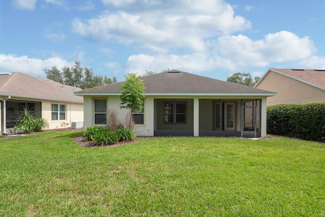 902 Heron Point Cir, Deland, FL 32724 - back of house with a sunroom, stucco siding, a lawn, and roof with shingles
