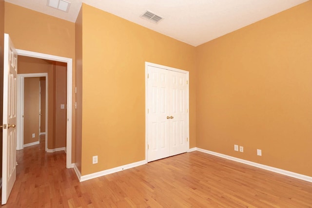 902 Heron Point Cir, Deland, FL 32724 - unfurnished bedroom with light wood-style floors, baseboards, and a closet