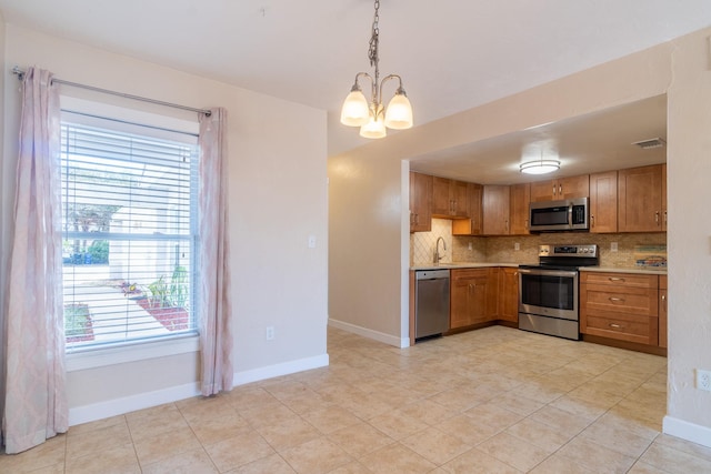 4602 Sandcastle Cir, Saint Augustine, FL 32084 - kitchen featuring stainless steel appliances, a notable chandelier, visible vents, light countertops, and decorative backsplash