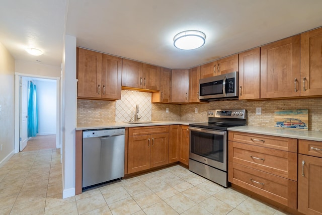 4602 Sandcastle Cir, Saint Augustine, FL 32084 - kitchen with light countertops, appliances with stainless steel finishes, brown cabinets, and a sink