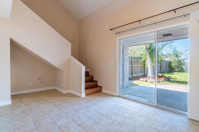 4602 Sandcastle Cir, Saint Augustine, FL 32084 - tiled empty room featuring baseboards, a ceiling fan, and high vaulted ceiling