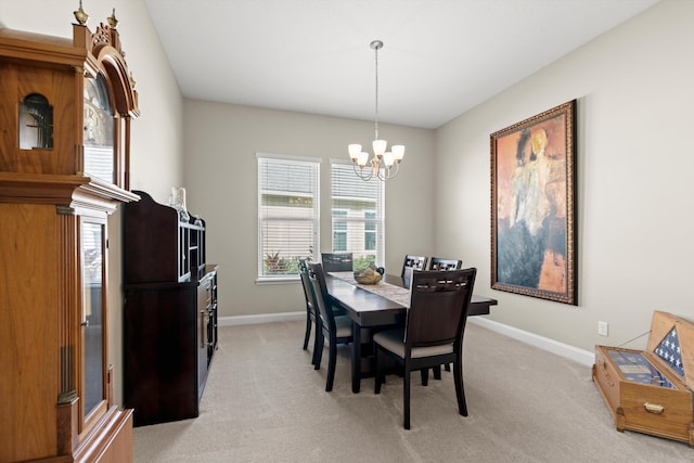 dining space featuring a notable chandelier and light carpet