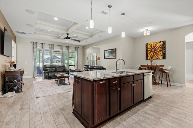 kitchen with pendant lighting, light hardwood / wood-style flooring, coffered ceiling, and sink