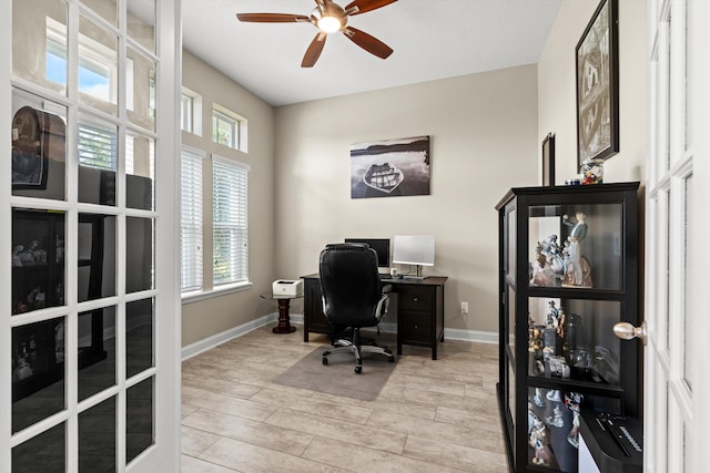 office featuring french doors, light wood-type flooring, and ceiling fan