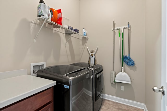 clothes washing area featuring independent washer and dryer