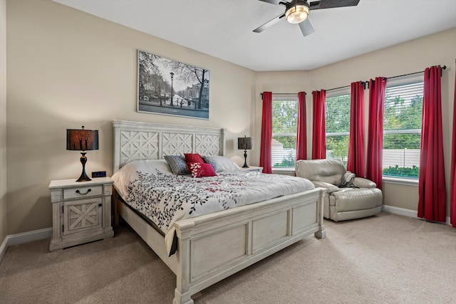 bedroom with ceiling fan and light colored carpet